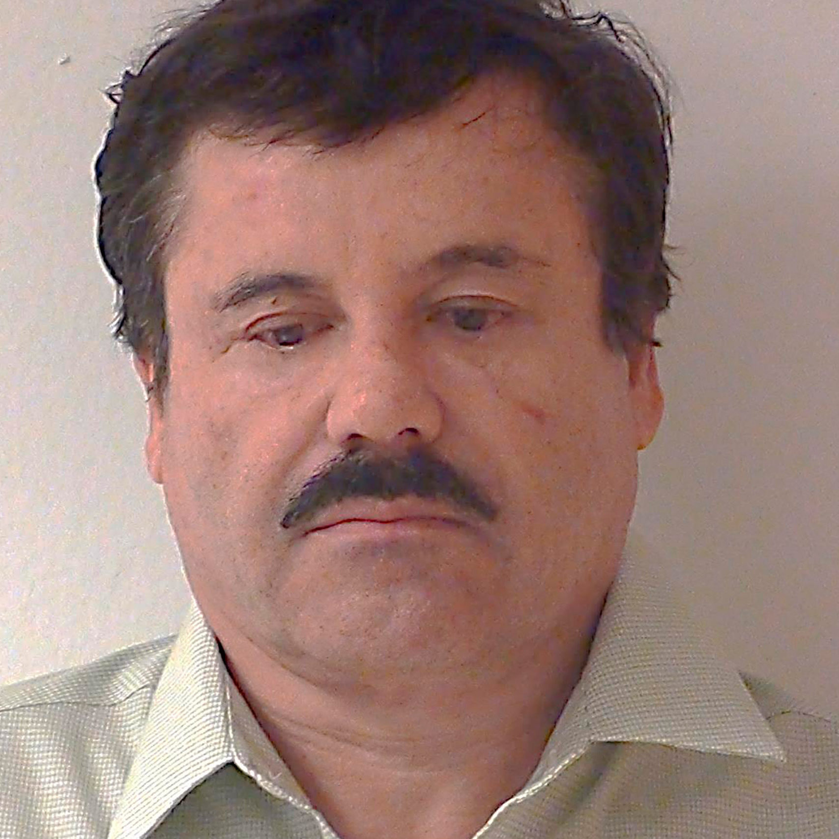 Mexican drug kingpin Joaquin "Shorty" Guzman is seen during his detention in Mexico City, in this undated handout photo provided by Mexico's Attorney General's office (PGR) on February 25, 2014. The identity of Guzman was publicly confirmed by Mexican authorities on February 25, 2014. REUTERS/PGR/Handout via Reuters (MEXICO - Tags: DRUGS SOCIETY CRIME LAW HEADSHOT) ATTENTION EDITORS - THIS IMAGE WAS PROVIDED BY A THIRD PARTY. FOR EDITORIAL USE ONLY. NOT FOR SALE FOR MARKETING OR ADVERTISING CAMPAIGNS. THIS PICTURE IS DISTRIBUTED EXACTLY AS RECEIVED BY REUTERS, AS A SERVICE TO CLIENTS - RTR3FQMJ